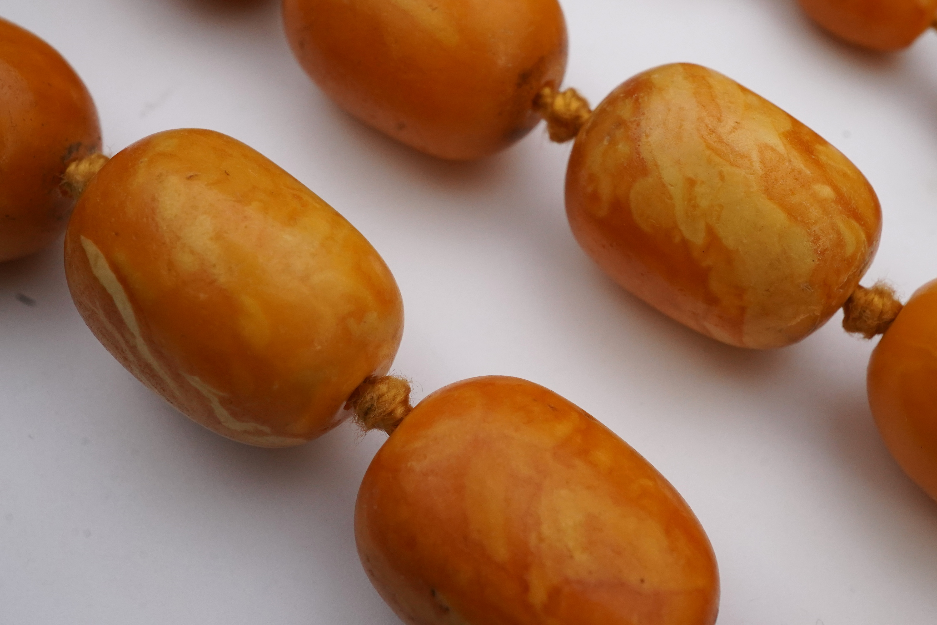 A single strand graduated oval amber bead necklace